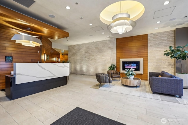 welcome area featuring a glass covered fireplace and visible vents