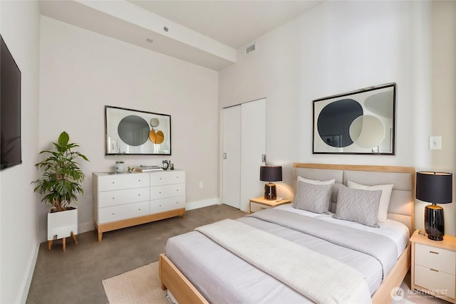 carpeted bedroom featuring visible vents and baseboards