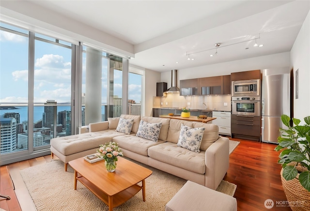 living area with a view of city and wood finished floors