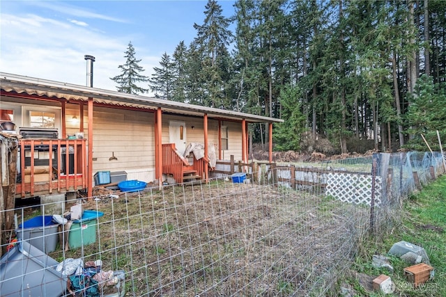 rear view of property featuring fence