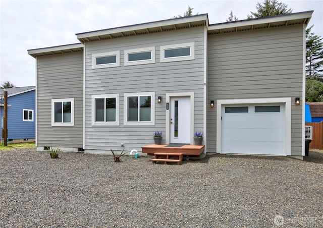 view of front of house featuring gravel driveway and an attached garage