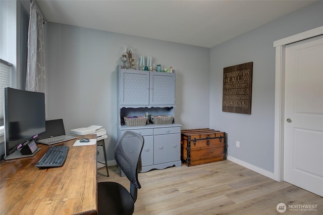 office area with light wood finished floors and baseboards