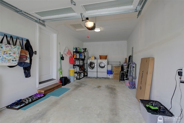 garage with washer and clothes dryer and a garage door opener