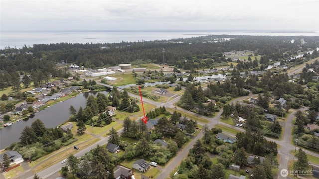 aerial view featuring a water view and a view of trees