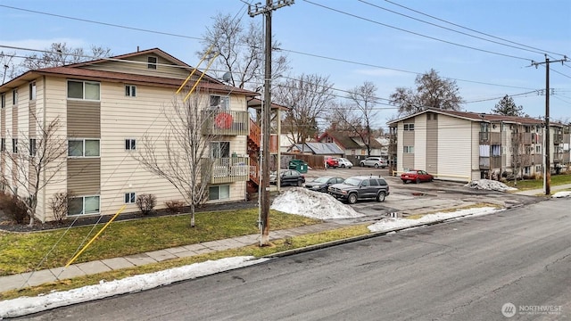 exterior space featuring a residential view, curbs, and sidewalks