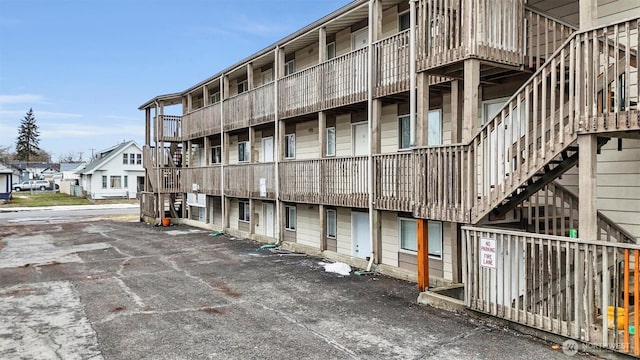 view of building exterior featuring a residential view and stairway