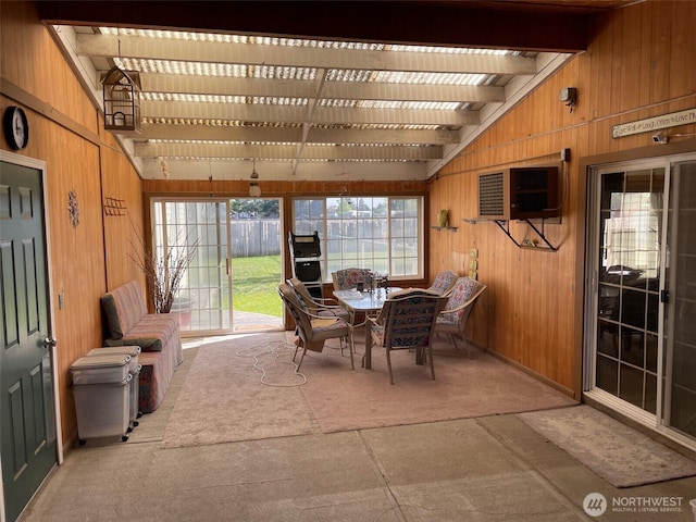 sunroom featuring a wealth of natural light and lofted ceiling with beams