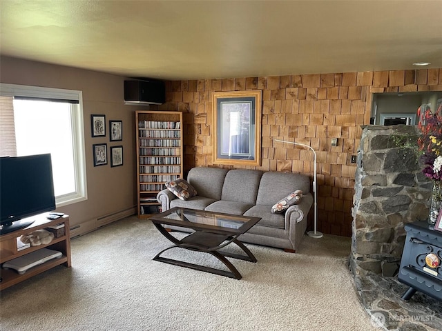 carpeted living room featuring a baseboard heating unit