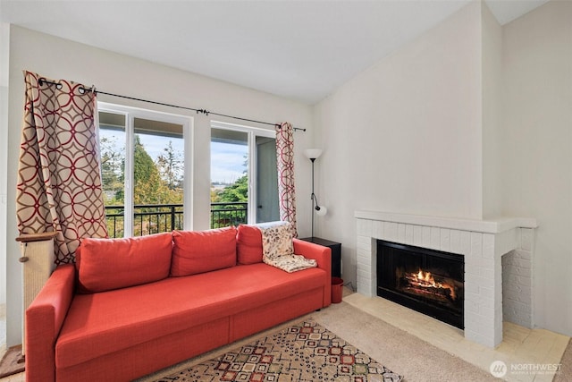 carpeted living area featuring a fireplace