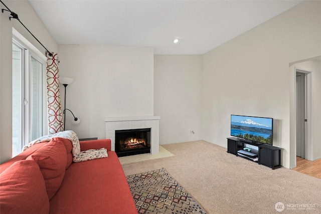 living room with carpet floors, a brick fireplace, and recessed lighting