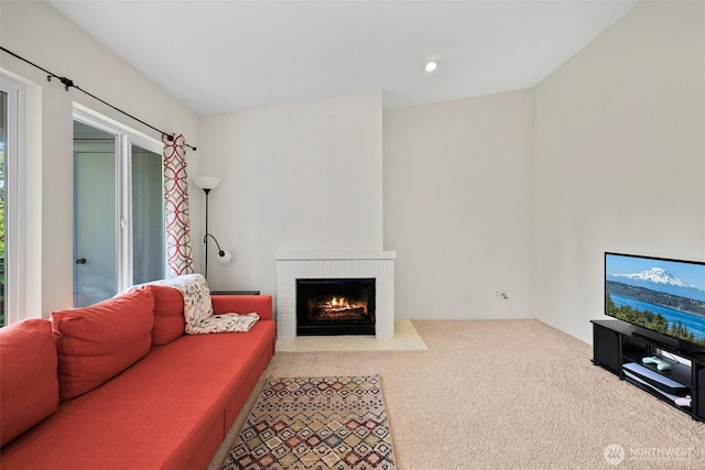 carpeted living room featuring a brick fireplace and recessed lighting