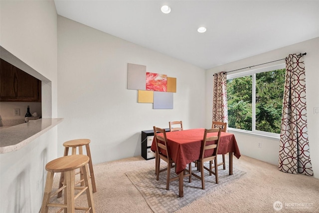 dining room featuring lofted ceiling, carpet, and recessed lighting