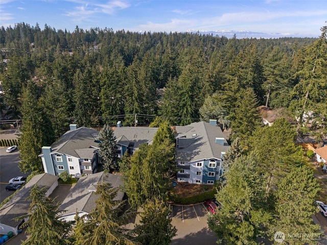 aerial view with a wooded view and a residential view