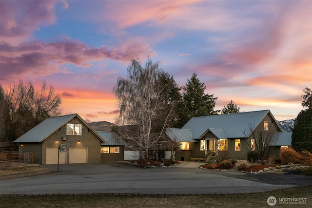 view of front of home featuring aphalt driveway and metal roof