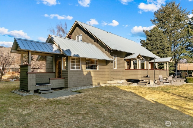 exterior space featuring a yard and metal roof