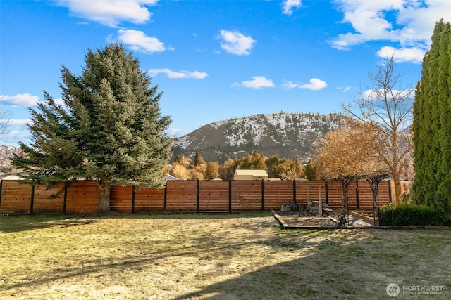 view of yard with a mountain view and fence