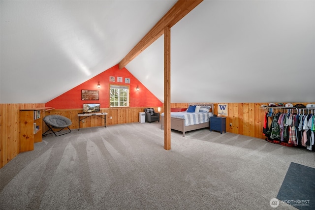 bedroom with wooden walls, carpet flooring, and vaulted ceiling with beams