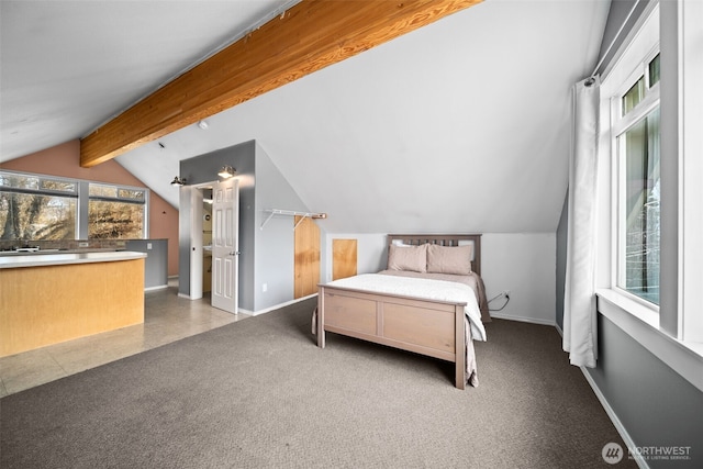 carpeted bedroom featuring lofted ceiling with beams and baseboards