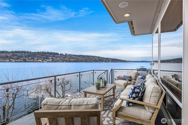 balcony with a water view and outdoor lounge area