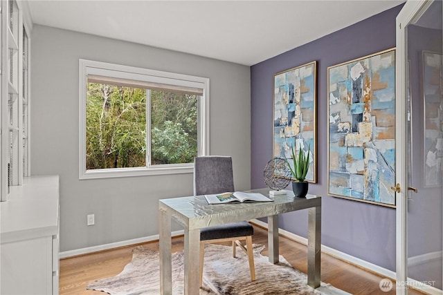 office area with light wood-style flooring and baseboards