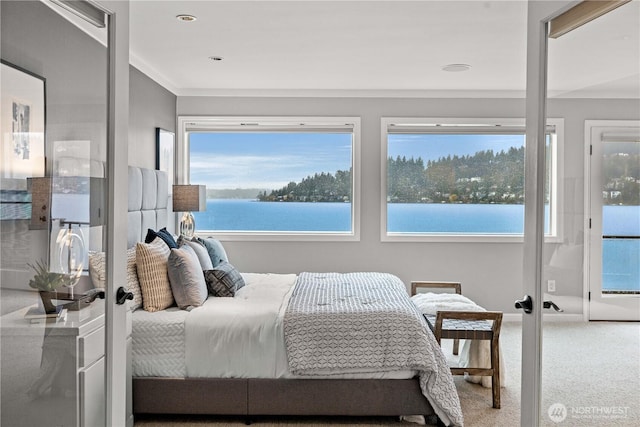 bedroom featuring baseboards, ornamental molding, a water view, french doors, and carpet floors