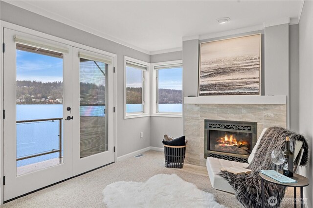 sitting room with carpet, french doors, a fireplace, visible vents, and baseboards