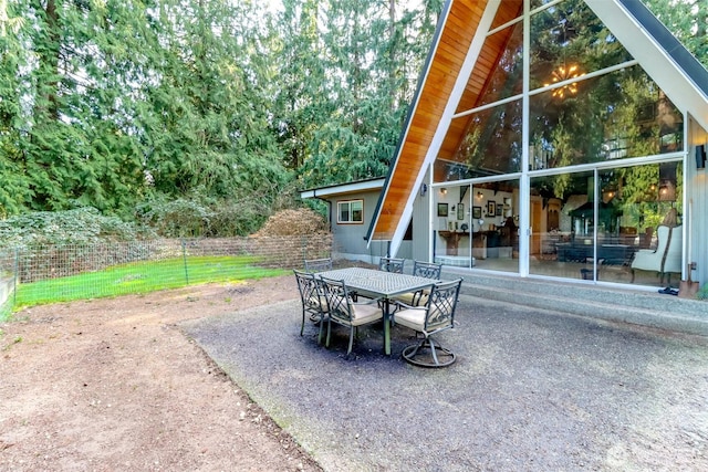 view of patio featuring fence and outdoor dining space