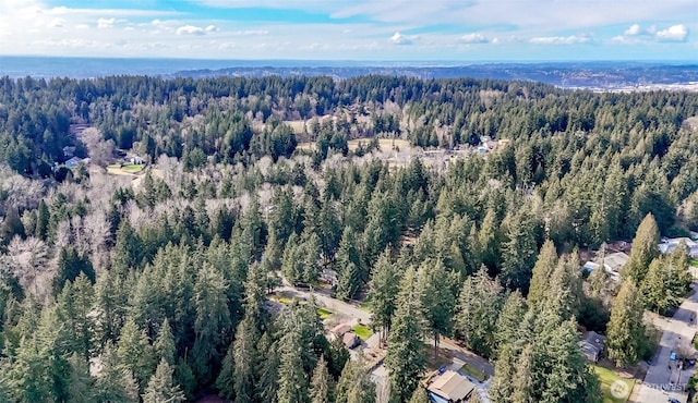 drone / aerial view featuring a forest view