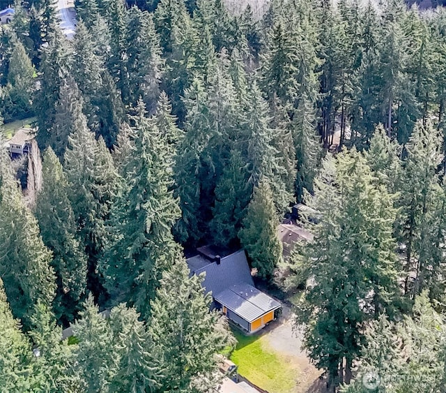 birds eye view of property with a view of trees