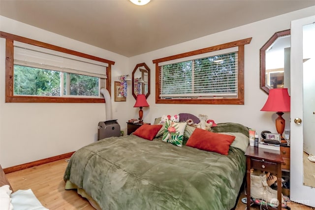 bedroom featuring baseboards and wood finished floors