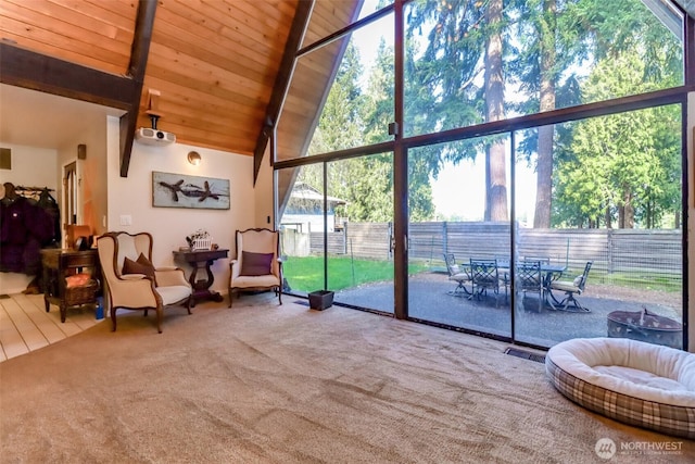 living area featuring visible vents, wood ceiling, carpet, expansive windows, and high vaulted ceiling