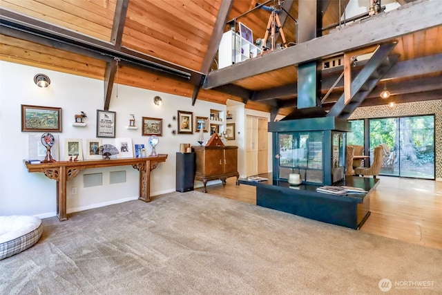 living area with beam ceiling, wood ceiling, carpet flooring, high vaulted ceiling, and baseboards