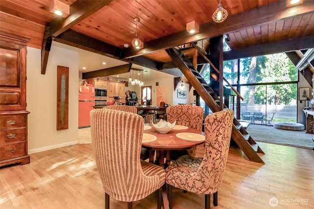 dining room featuring beamed ceiling, wooden ceiling, and light wood-style floors