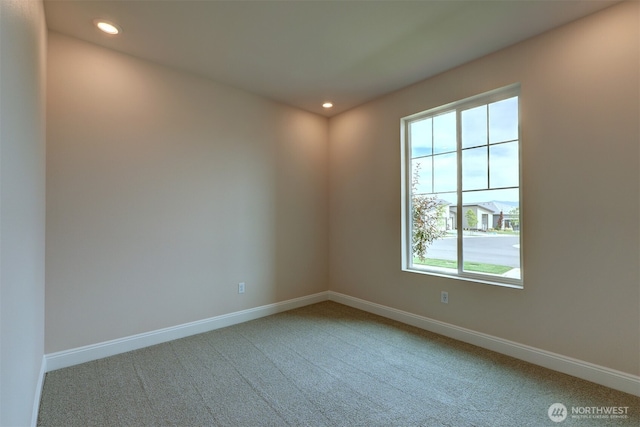 carpeted empty room featuring recessed lighting and baseboards