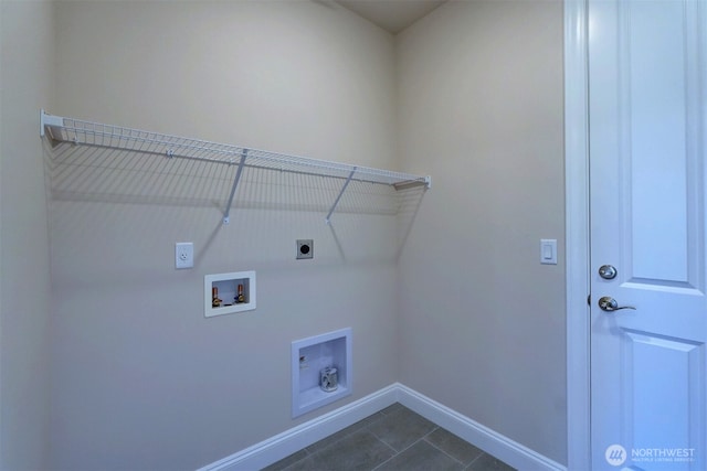 clothes washing area with laundry area, baseboards, dark tile patterned floors, washer hookup, and electric dryer hookup