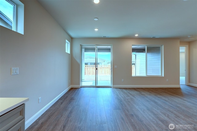 interior space with recessed lighting, dark wood-style flooring, visible vents, and baseboards