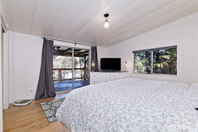 471 SE Old Arcadia Rd, Shelton, WA 98584 - bedroom featuring light wood-style flooring, access to exterior, and vaulted ceiling