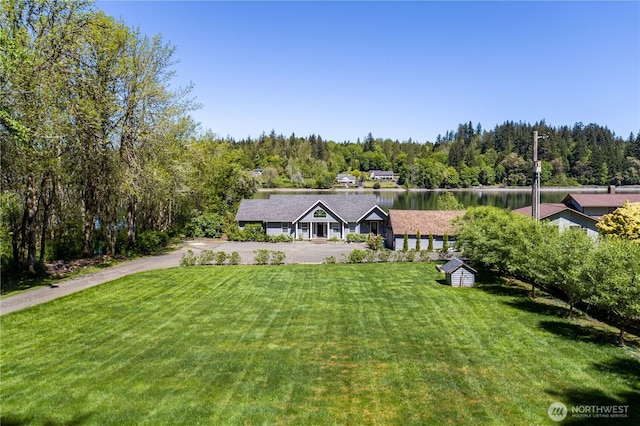 471 SE Old Arcadia Rd, Shelton, WA 98584 - view of front of house featuring a front lawn, a wooded view, driveway, and a water view
