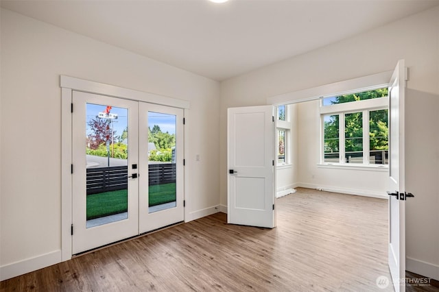 entryway with french doors, baseboards, and wood finished floors