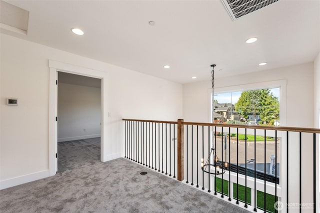 hallway with recessed lighting, carpet flooring, visible vents, and baseboards