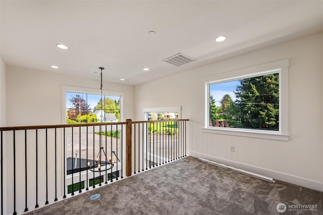 carpeted empty room featuring baseboards, plenty of natural light, visible vents, and recessed lighting