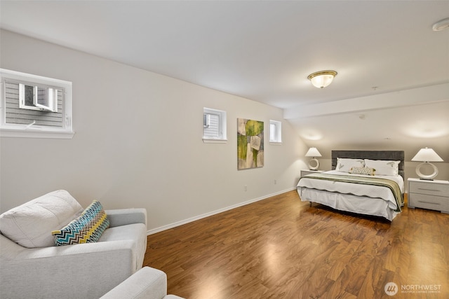 bedroom featuring baseboards and wood finished floors