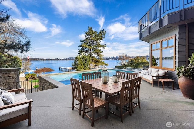 view of patio featuring an outdoor hangout area, an infinity pool, and a water view