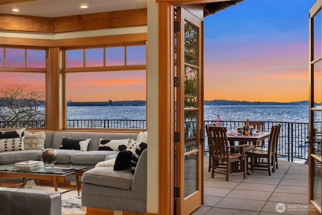 interior space featuring tile patterned floors and a water view