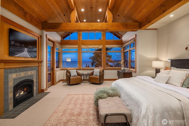 bedroom with carpet, vaulted ceiling with beams, wooden ceiling, and a fireplace