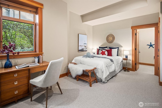 bedroom featuring carpet flooring, baseboards, and built in desk