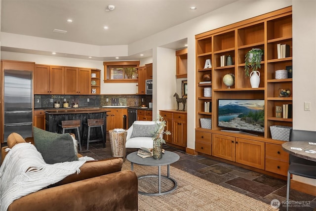 living area with recessed lighting and stone tile flooring