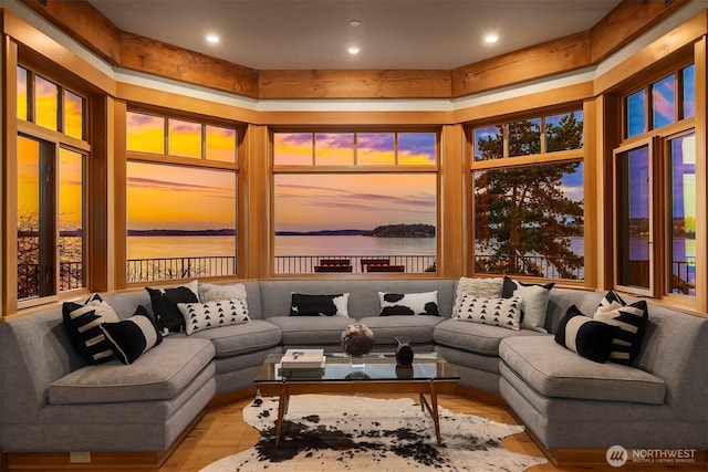 living area featuring a water view and wood finished floors