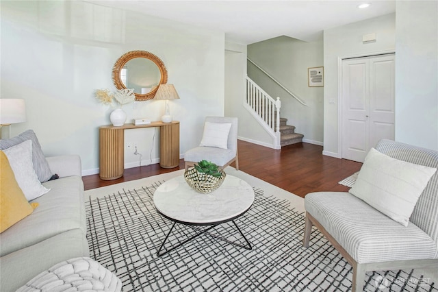 living room featuring stairs, recessed lighting, baseboards, and wood finished floors