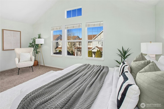 carpeted bedroom featuring high vaulted ceiling and baseboards